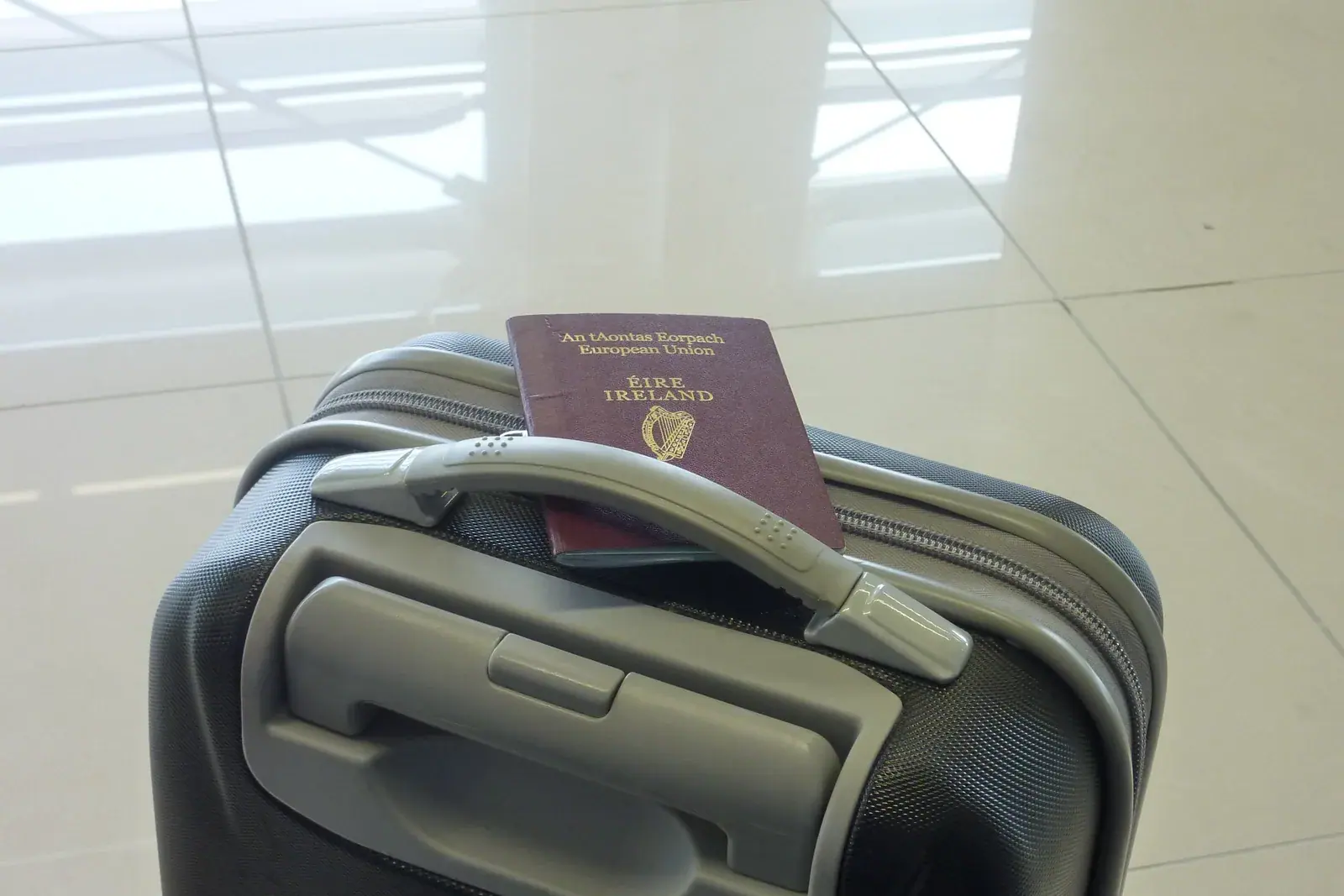 Passport placed on a suitcase before an international trip