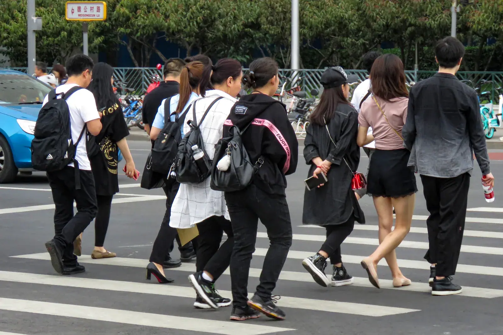 Pedestrians crossing a marked city street in Beijing