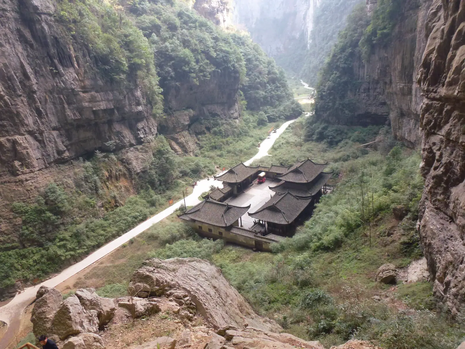 Limestone arch, forest and walking path at Wulong Three Natural Bridges in Chongqing